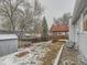 Large backyard features mature trees, partially fenced yard, and upper deck on home at 3833 S Bahama St, Aurora, CO 80013