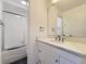 Bright bathroom with a single vanity, framed mirror, and bathtub with glass doors at 3833 S Bahama St, Aurora, CO 80013