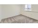 Carpeted bedroom with large window and neutral tones at 3833 S Bahama St, Aurora, CO 80013