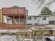 Exterior view of home showing upper and lower decks, patio, landscaping and mature trees at 3833 S Bahama St, Aurora, CO 80013