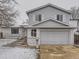 Charming two-story home with light blue siding, a two-car garage, and well-maintained front yard at 3833 S Bahama St, Aurora, CO 80013