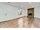 Living room with hard wood floors, brick fireplace, and ample natural light at 3833 S Bahama St, Aurora, CO 80013