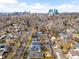 Expansive aerial view of the neighborhood showcasing the lush greenery, mature trees, and distant city skyline, for urban meets nature at 438 S Emerson St, Denver, CO 80209