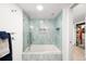 Modern bathroom features custom tile work, a sleek glass shower door and a soaking tub at 438 S Emerson St, Denver, CO 80209