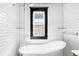 Classic bathroom with subway tile and a sleek soaking tub at 438 S Emerson St, Denver, CO 80209