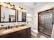 Bathroom with double vanity, decorative mirrors, and glass-enclosed shower at 438 S Emerson St, Denver, CO 80209