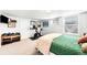 Bright bedroom features an exercise bike, weights, and a comfortable bed at 438 S Emerson St, Denver, CO 80209