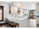 Bright, remodeled kitchen featuring white cabinetry, quartz countertops, hexagon tile floors and stainless steel appliances for modern living at 438 S Emerson St, Denver, CO 80209