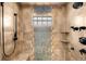 Shower featuring decorative tile work, shower bench, and dual shower heads at 438 S Emerson St, Denver, CO 80209