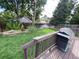 Well-maintained backyard featuring a lawn, garden bed, privacy fence, and a deck with a grill at 540 S Forest St # A2, Denver, CO 80246