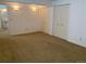 Carpeted bedroom with neutral walls, leading to a bathroom and closets at 540 S Forest St # A2, Denver, CO 80246