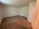 Carpeted bedroom with neutral walls, a large window, and a door at 540 S Forest St # A2, Denver, CO 80246