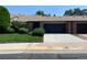 Exterior view of this townhome featuring a well-manicured lawn and an attached garage at 540 S Forest St # A2, Denver, CO 80246