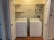 Bright laundry room features white washer and dryer with storage shelves at 540 S Forest St # A2, Denver, CO 80246