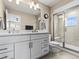 Clean and modern bathroom with double vanity, sleek fixtures, and glass-enclosed shower at 6162 W 28Th Ct, Edgewater, CO 80214