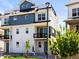 Charming three-story home with a balcony, modern design, and well-maintained landscaping at 6162 W 28Th Ct, Edgewater, CO 80214