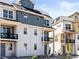 New townhomes showcasing multiple balconies, bright colors, and modern designs at 6162 W 28Th Ct, Edgewater, CO 80214