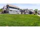 Modern townhomes featuring blue siding, white trim, and attached garages, surrounded by a lush green lawn at 6162 W 28Th Ct, Edgewater, CO 80214