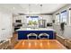 Modern kitchen with a large island, stainless steel appliances, and white cabinetry at 6162 W 28Th Ct, Edgewater, CO 80214