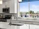 Modern kitchen featuring white cabinetry, stainless steel appliances, and a view of the backyard at 6162 W 28Th Ct, Edgewater, CO 80214