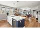 Bright open-concept living space with hardwood floors seamlessly connecting kitchen, dining, and living areas at 6162 W 28Th Ct, Edgewater, CO 80214