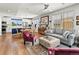 Open-concept living room featuring hardwood floors, a kitchen island, and comfortable seating at 6162 W 28Th Ct, Edgewater, CO 80214
