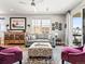 Comfortable living room with a cozy gray sofa, patterned ottoman, and elegant decor at 6162 W 28Th Ct, Edgewater, CO 80214