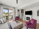 Comfortable living area with fireplace, patio access, and modern furnishings at 6162 W 28Th Ct, Edgewater, CO 80214