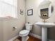 Chic powder room with modern fixtures, stylish lighting, and a pedestal sink at 6162 W 28Th Ct, Edgewater, CO 80214
