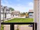 Scenic view from the balcony showcasing a lush green lawn surrounded by stylish townhomes in a community at 6162 W 28Th Ct, Edgewater, CO 80214