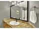 Bathroom featuring a large mirror and a granite countertop with a sleek white sink at 3720 Pecos Trl, Castle Rock, CO 80109