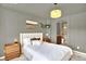 Bright bedroom with attached bathroom featuring neutral tones, a stylish light fixture, and a decorative painting at 3720 Pecos Trl, Castle Rock, CO 80109
