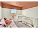 Bedroom room with a crib, a changing table and a view of the neighborhood through a window at 3720 Pecos Trl, Castle Rock, CO 80109