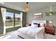 Serene bedroom offers neutral decor, large windows, and stylish lighting fixtures at 3720 Pecos Trl, Castle Rock, CO 80109