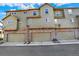 Green townhouse featuring three garages and decorative stone and siding details at 3720 Pecos Trl, Castle Rock, CO 80109