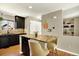 This stylish kitchen features dark cabinets, stainless appliances, and an island with seating and a granite countertop at 3720 Pecos Trl, Castle Rock, CO 80109