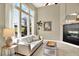 Bright living room with large windows, fireplace, and comfortable seating at 3720 Pecos Trl, Castle Rock, CO 80109