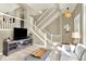 Bright living room featuring an open staircase, neutral decor, and modern furnishings at 3720 Pecos Trl, Castle Rock, CO 80109