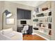 Cozy home office with built-in desk, shelving, and comfortable seating at 3720 Pecos Trl, Castle Rock, CO 80109