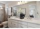 Spacious bathroom with double sinks, a large mirror, and a glass shower enclosure at 4588 S Versailles St # A, Aurora, CO 80015