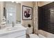 Modern bathroom with a shower-tub combo and stylish dark tile at 4588 S Versailles St # A, Aurora, CO 80015