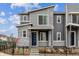 Contemporary townhome featuring stone veneer, gray siding, and a dark blue front door at 4588 S Versailles St # A, Aurora, CO 80015