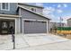 Attached garage with gray door at 4588 S Versailles St # A, Aurora, CO 80015