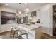Modern kitchen featuring a large island, stainless steel appliances, and sleek white cabinetry at 4588 S Versailles St # A, Aurora, CO 80015