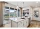 Bright kitchen island featuring a stainless steel sink and sliding glass doors to the outside at 4588 S Versailles St # A, Aurora, CO 80015