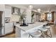 Modern kitchen featuring a large island, stainless steel appliances, and sleek white cabinetry at 4588 S Versailles St # A, Aurora, CO 80015