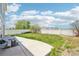A spacious backyard with a white fence, grassy area, and a concrete patio at 5571 Killarney St, Denver, CO 80249