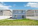Home's backyard featuring a white fence, grassy area, and a concrete patio at 5571 Killarney St, Denver, CO 80249