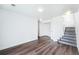 Spacious finished basement area with wood floors and access to the upper floor at 5571 Killarney St, Denver, CO 80249