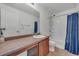 Bathroom featuring a vanity and a shower-tub combination at 5571 Killarney St, Denver, CO 80249